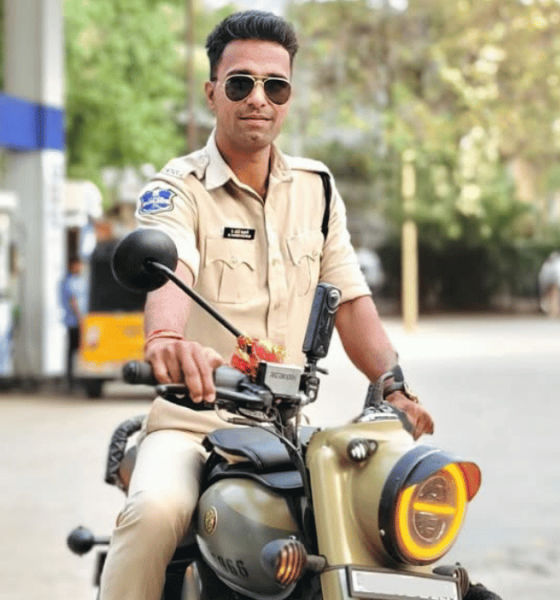 Traffic police officer Naveen Singh recording a moto vlog during a road stop, capturing real-time traffic interaction and road safety awareness through a helmet-mounted camera.