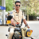 Traffic police officer Naveen Singh recording a moto vlog during a road stop, capturing real-time traffic interaction and road safety awareness through a helmet-mounted camera.