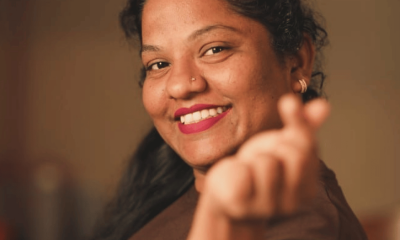 A young barista at a café in Bandra, Mumbai, interacting warmly with customers, representing Suraksha Suvarna’s journey from everyday café work to becoming a relatable social media personality through candid, real-life content.