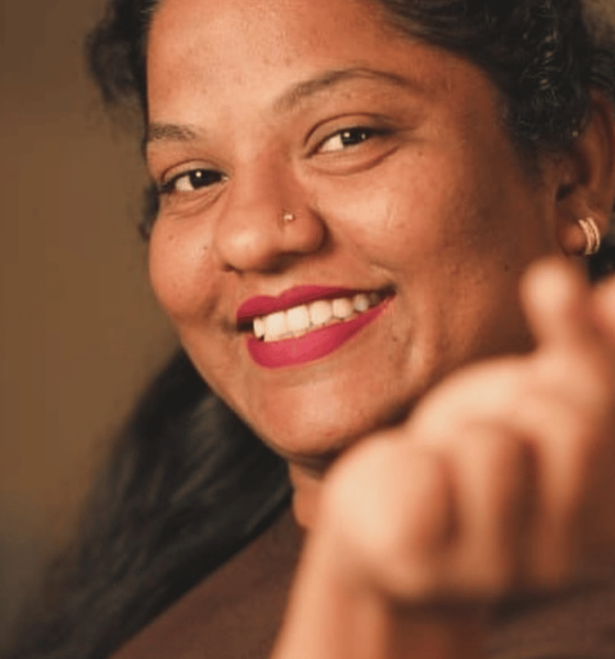 A young barista at a café in Bandra, Mumbai, interacting warmly with customers, representing Suraksha Suvarna’s journey from everyday café work to becoming a relatable social media personality through candid, real-life content.